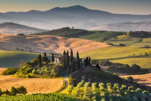 Scenic Tuscany landscape with rolling hills and valleys in golden morning light, Val d'Orcia, Italy